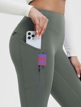 Grey fleece-lined yoga leggings with phone and card in side pocket. #color_Dark Gray