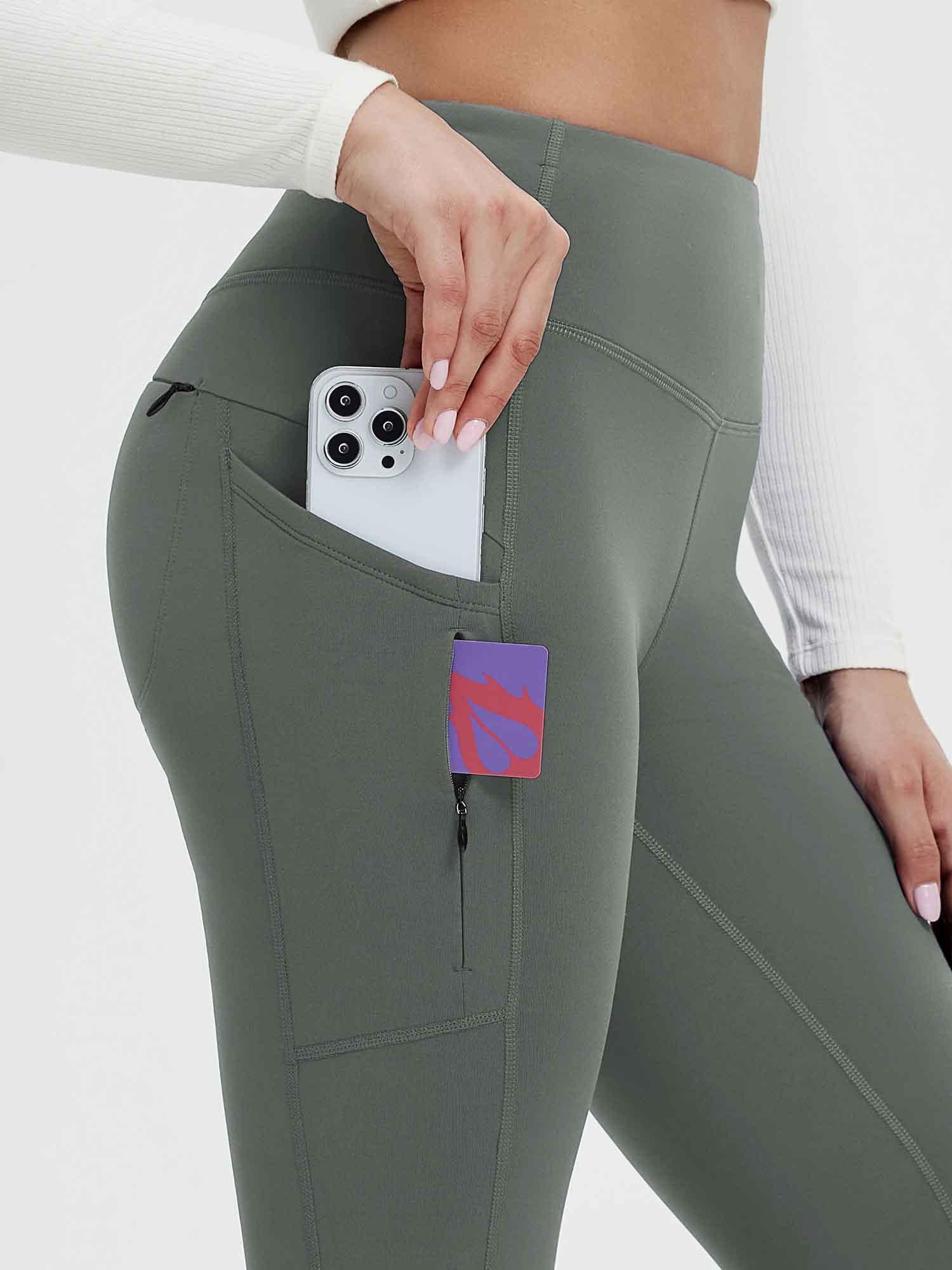 Grey fleece-lined yoga leggings with phone and card in side pocket. #color_Dark Gray