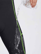 Black men's thermal cycling tights with neon green piping, showing water-repellent feature. #color_Flourescent Green