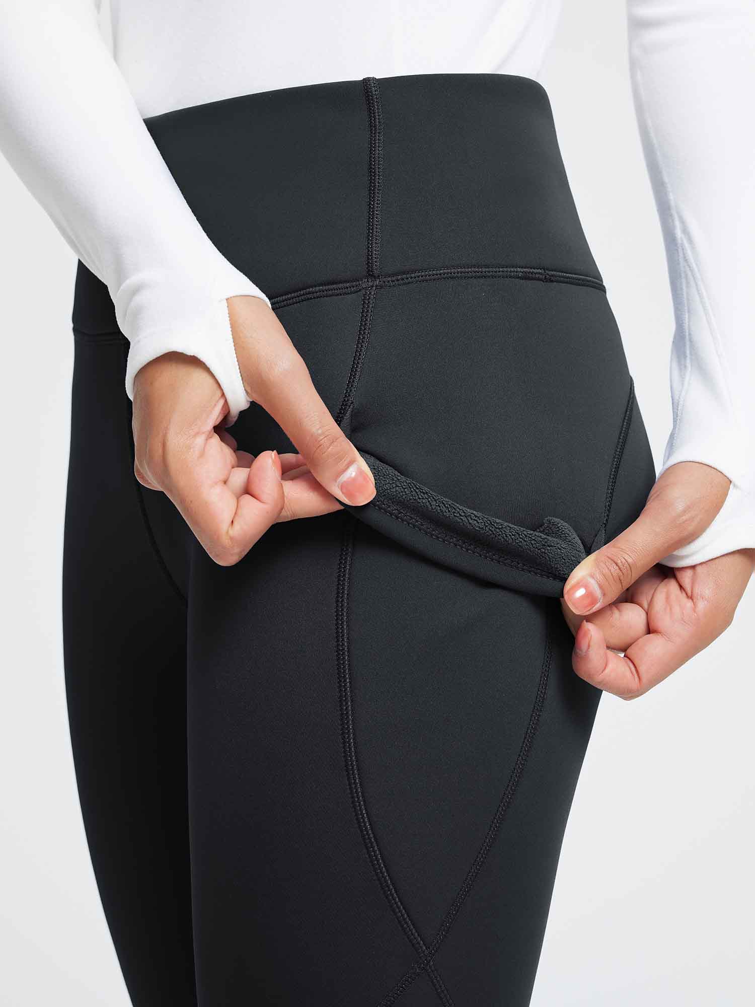 Black thermal fleece-lined yoga leggings, high-waist design, soft interior. Perfect for cold weather yoga.