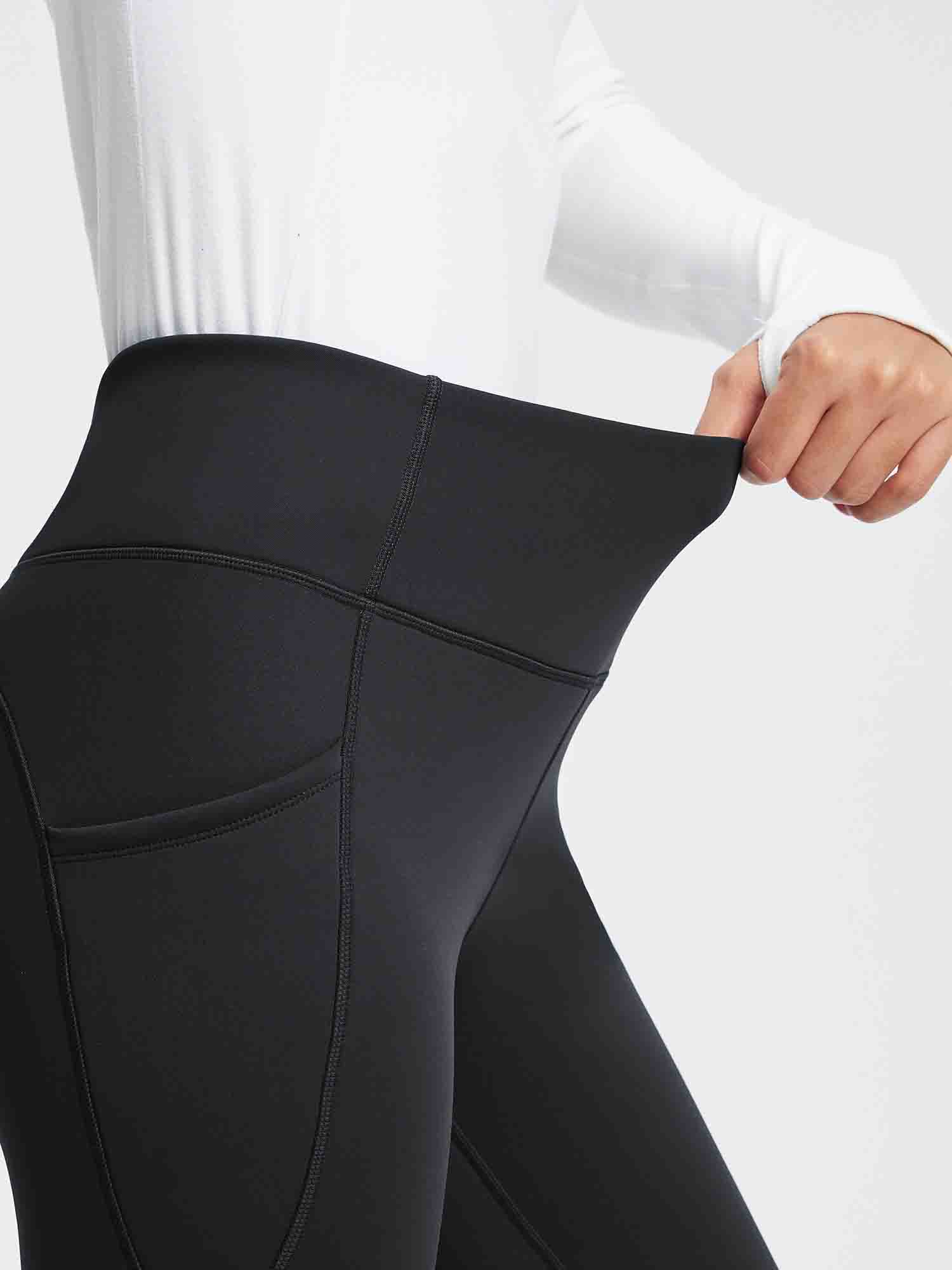 Black thermal fleece high-waist yoga leggings with pockets, showing the stretchy waistband. #color_Black