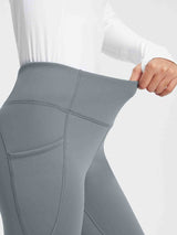 Gray thermal fleece yoga leggings with high waist and side pockets, showing fabric stretch. #color_Dark Gray
