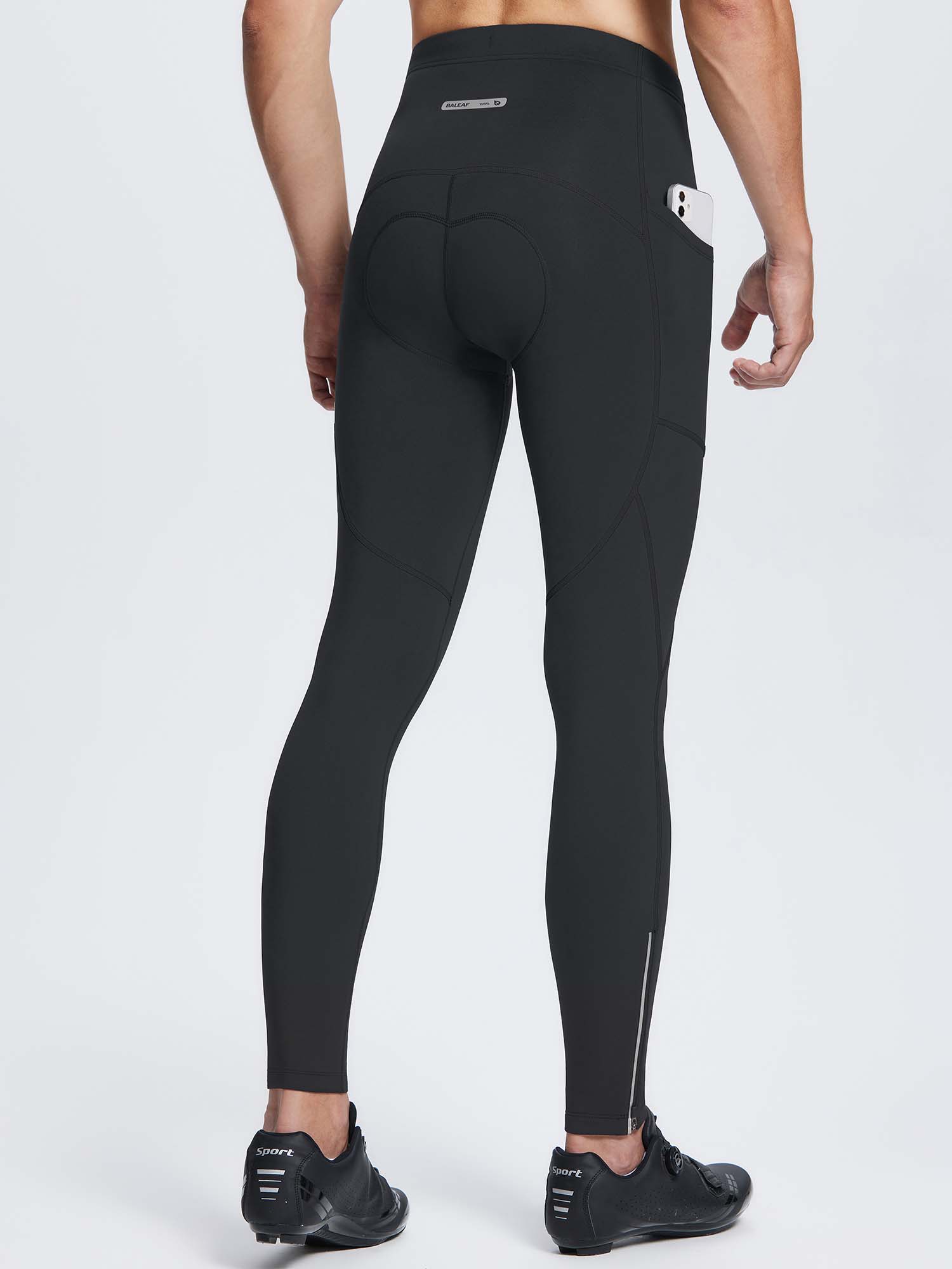 Men's black fleece-padded thermal cycling tights with side pockets and ankle zippers. #color_Black