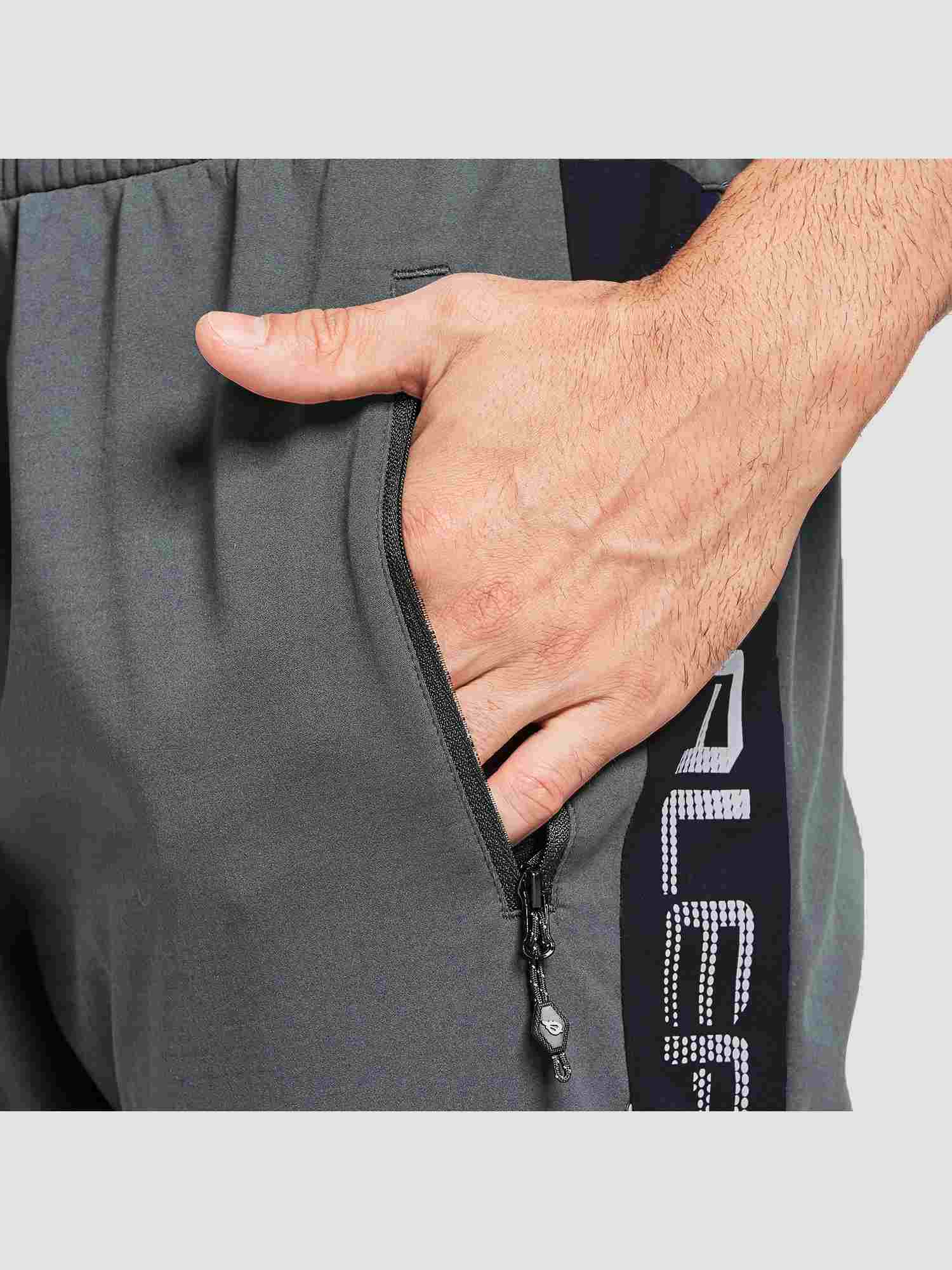 Men's knit fleece cycling pants in gray with zippered pocket and reflective side detail. #color_Gray/Black