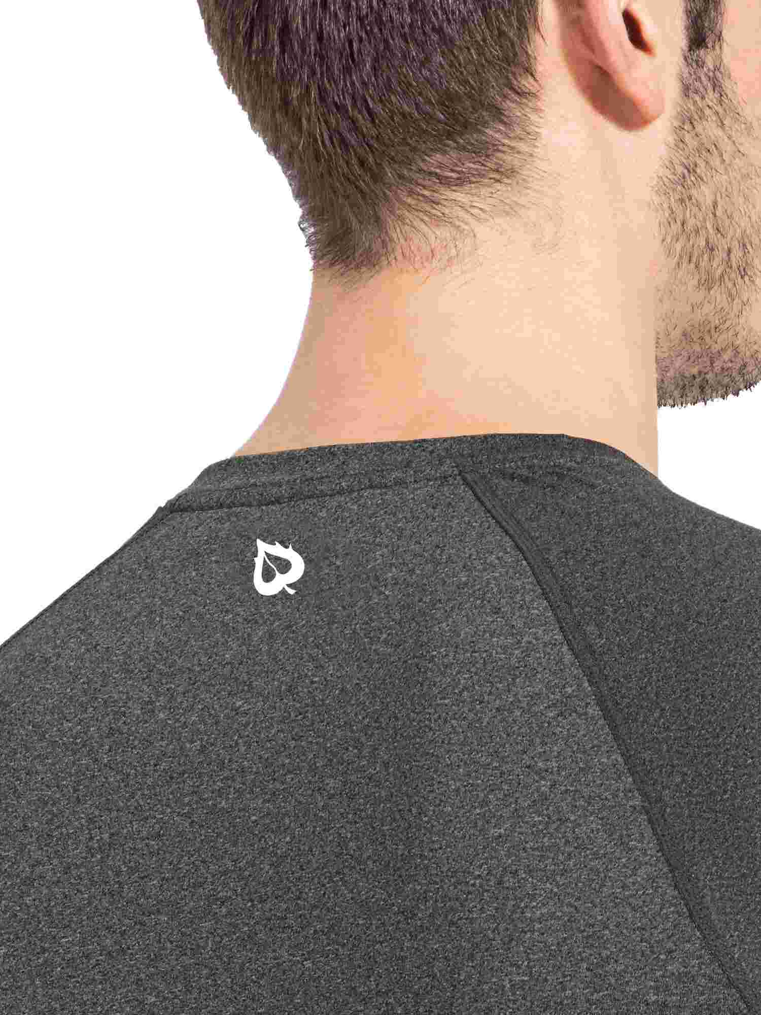 Close-up of the shoulder and neck of a dark heather gray men's long-sleeved crewneck shirt, featuring a small white leaf logo on the upper back. #color_Heather Gray