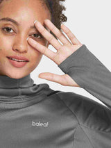 Woman in gray Baleaf UPF 50+ hiking shirt with thumbholes and raised collar. #color_Dark Gray