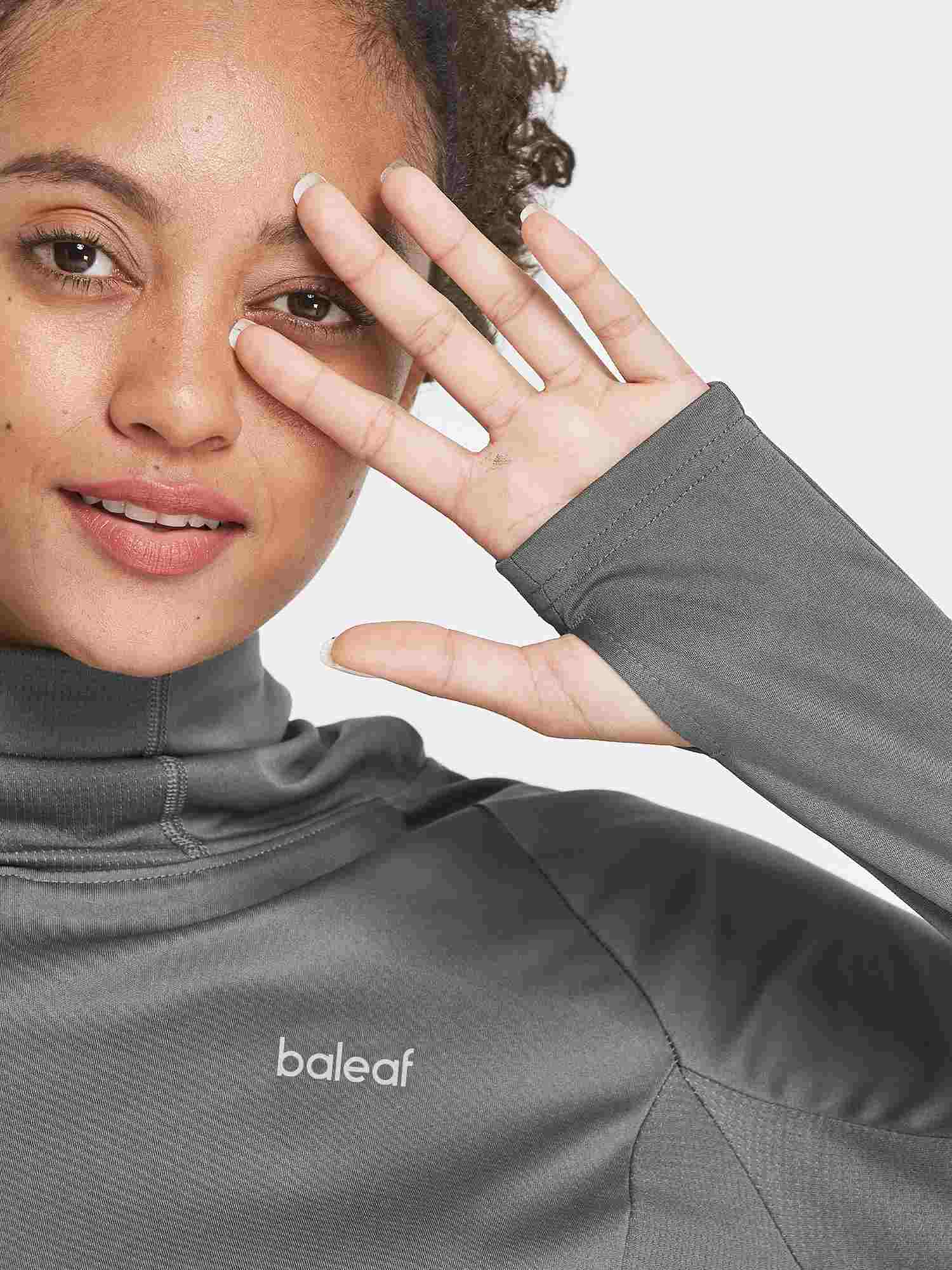 Woman in gray Baleaf UPF 50+ hiking shirt with thumbholes and raised collar. #color_Dark Gray