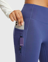Navy blue thermal flare yoga pants with phone and zip pocket. High-waisted activewear with fleece lining.