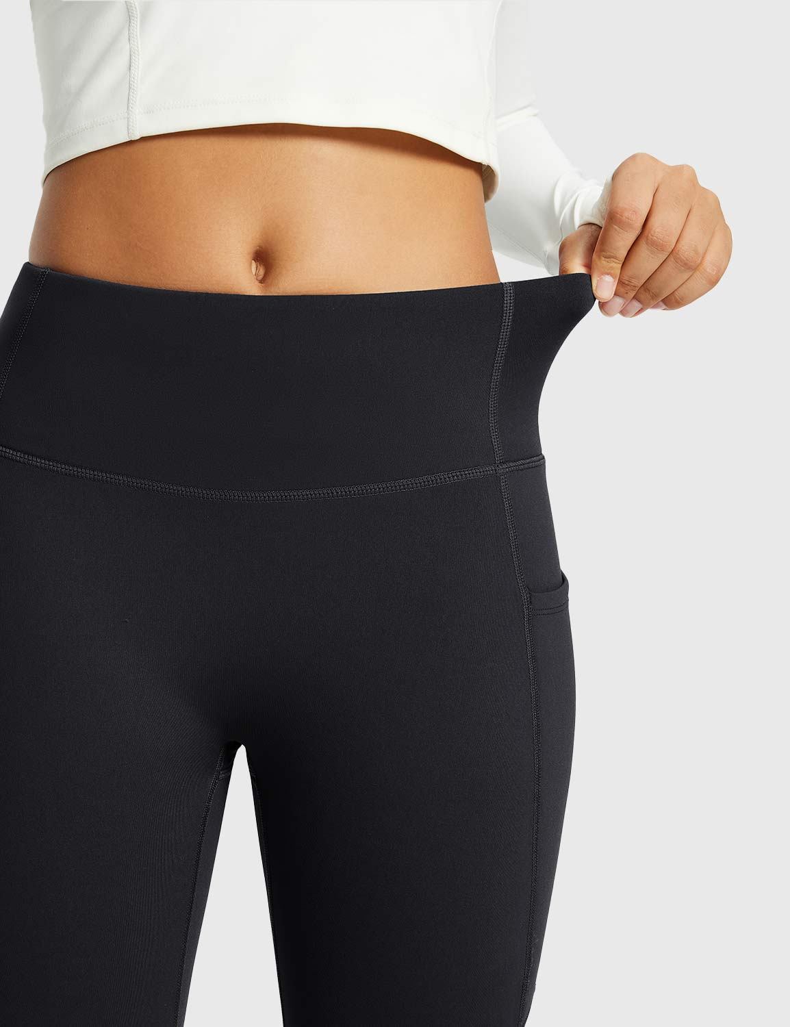 Black thermal warm flare pants with pockets, showcasing stretch waistband for comfortable fit. #color_Black