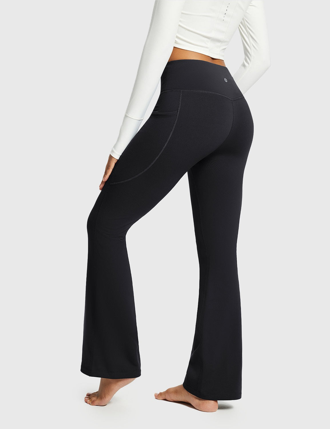 Black thermal warm flare pants with a side pocket and a v-shaped back seam. #color_Black