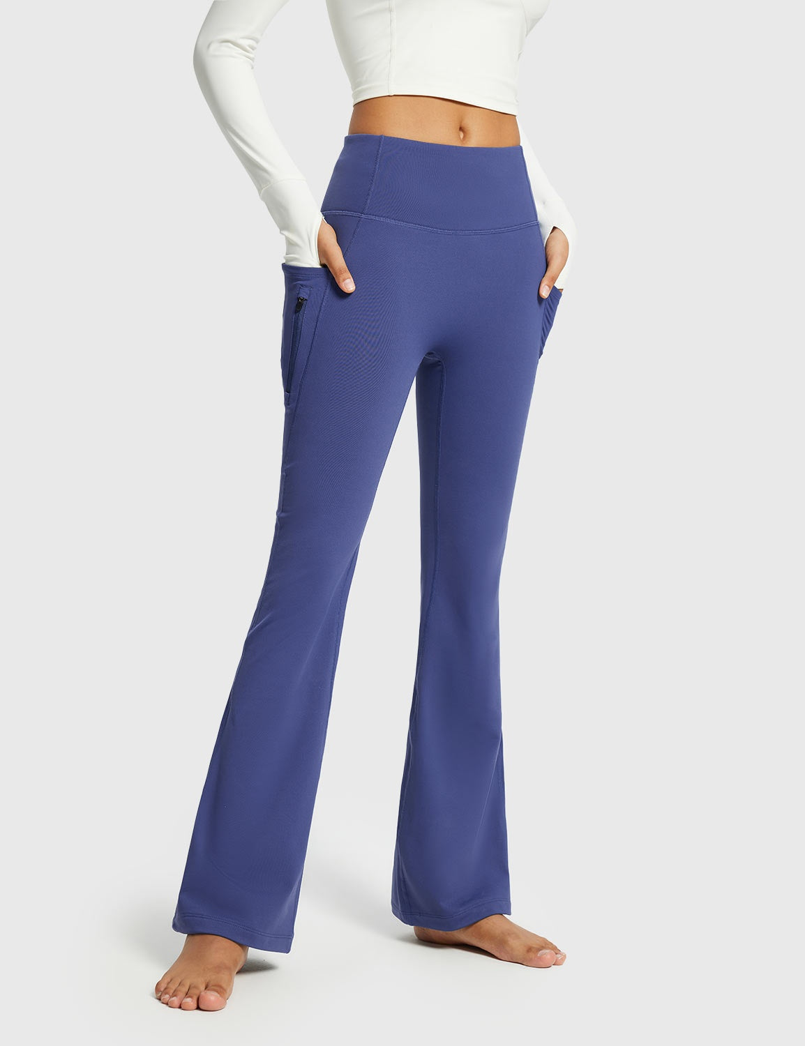 Navy blue thermal flare yoga pants with zipper pockets. High-waisted, bootcut activewear. #color_Navy Blue