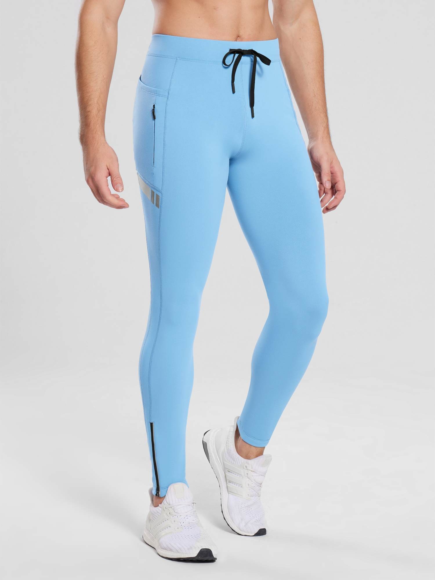 Light blue fleece-lined men's cycling tights with pockets and ankle zippers. Ideal for cold weather.