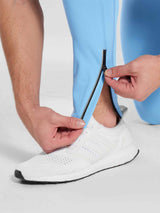 Men's light blue fleece-lined cycling tights with ankle zipper and reflective detail. #color_Blue
