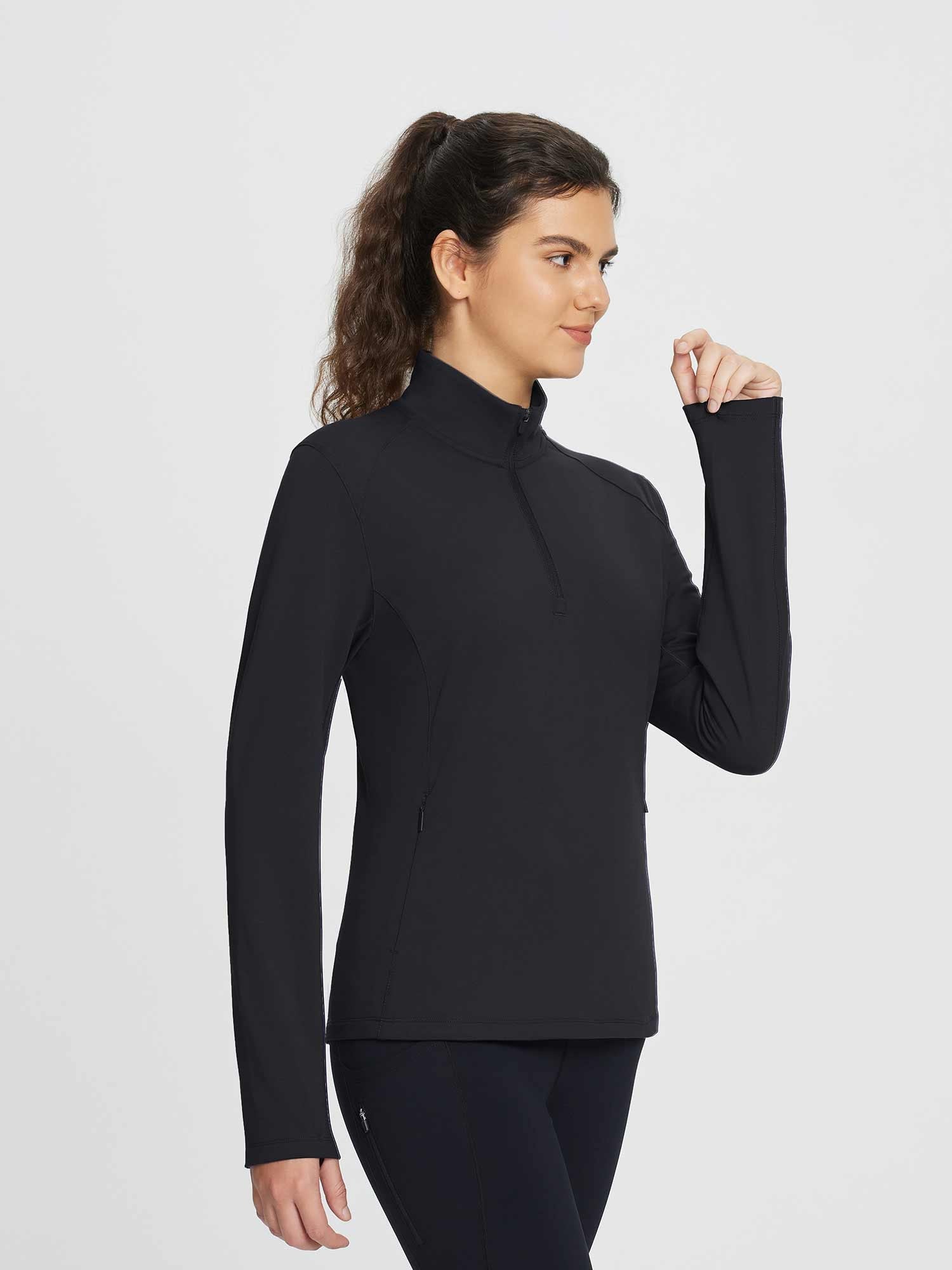 Women's black half-zip fleece pullover golf top with zippered pockets and high neck. #color_Black