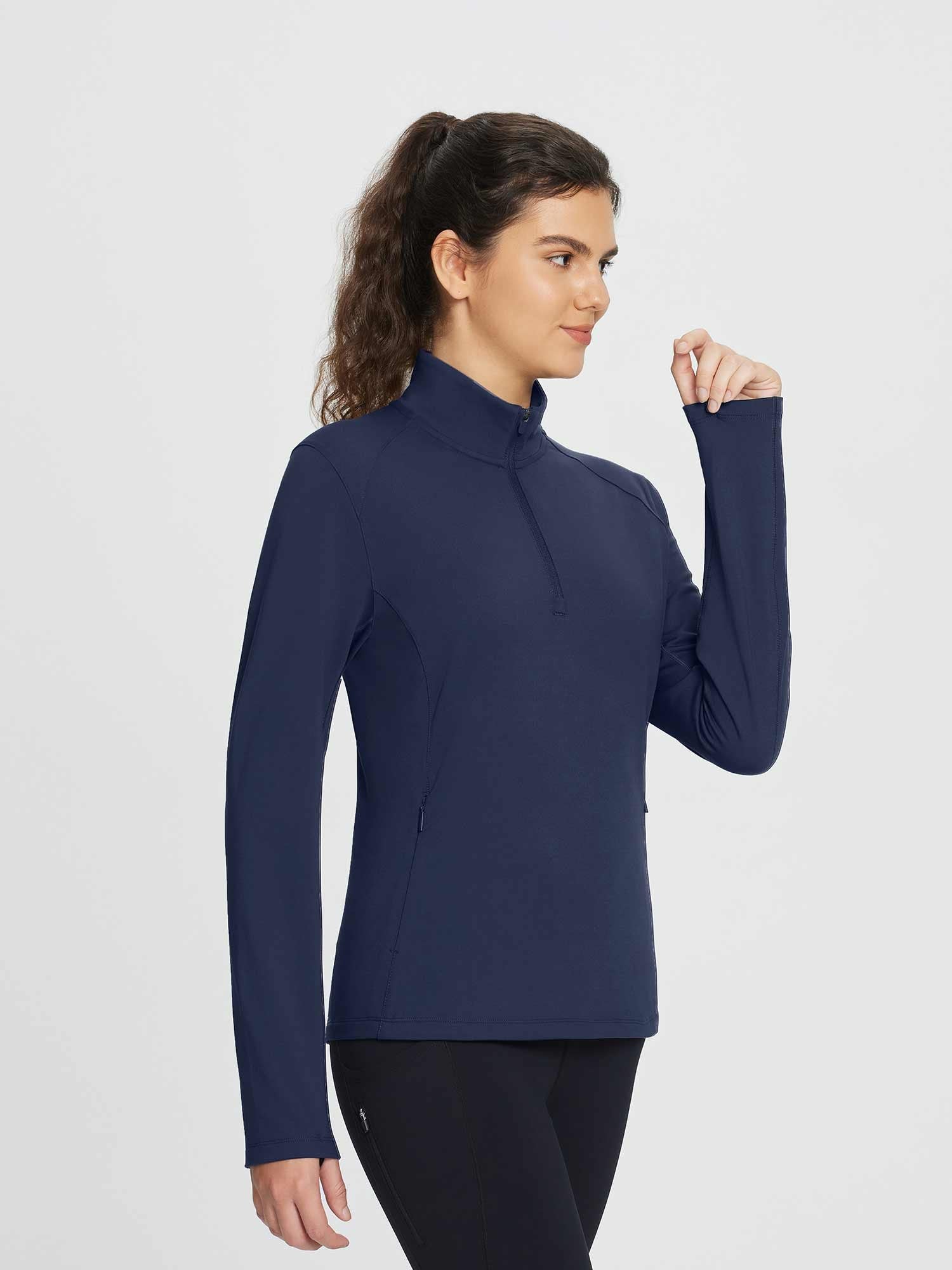 Navy blue women's half-zip fleece pullover golf top with zipper pockets and elastic cuffs.