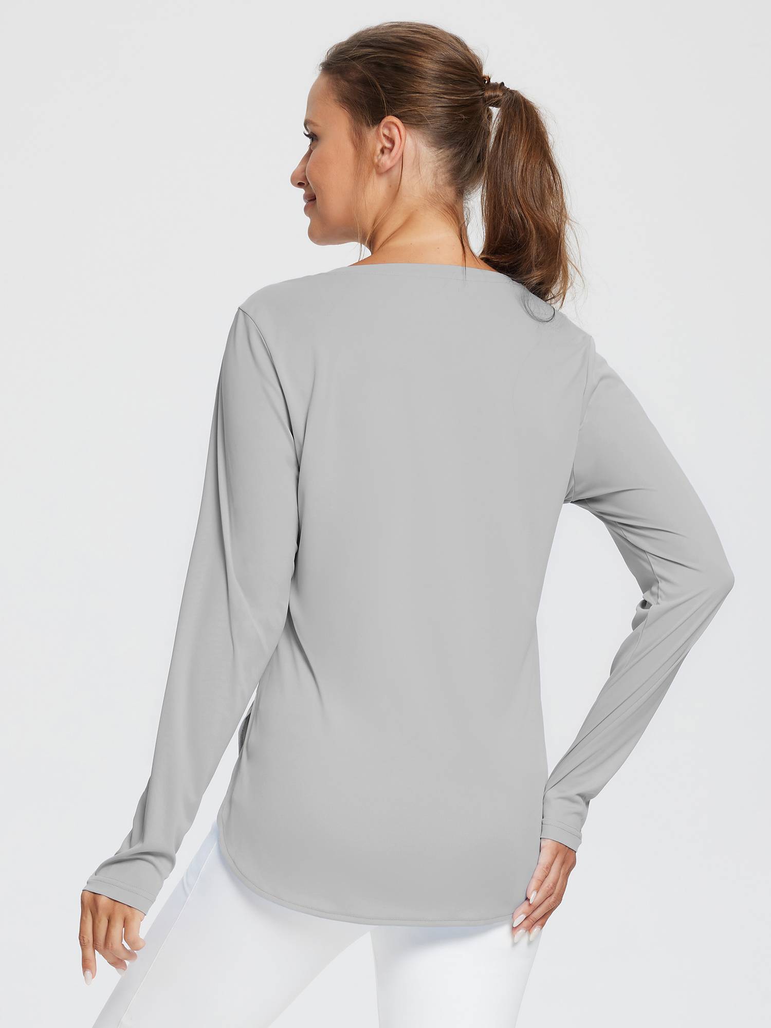 Woman's light gray long-sleeve outdoor t-shirt, back view, with thumbholes and high-low hem.