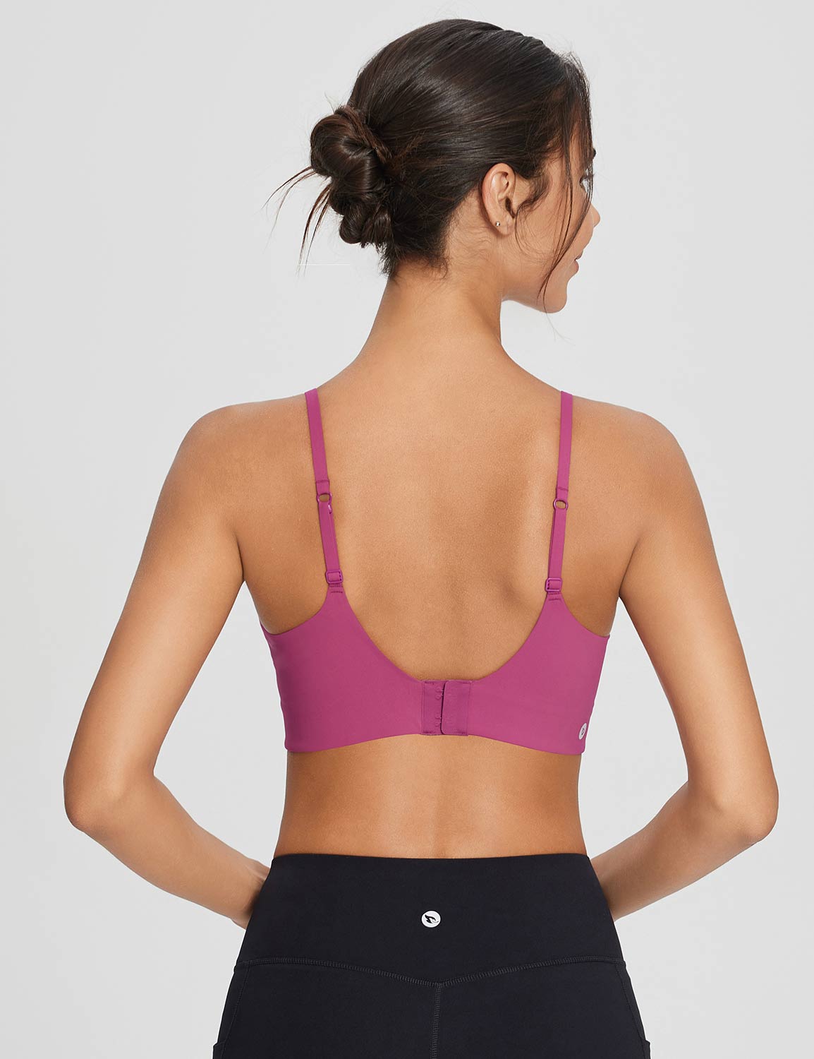 Pink Y-back sports bra with adjustable straps and hook closure, shown from back with black leggings. #color_Cactus Flower
