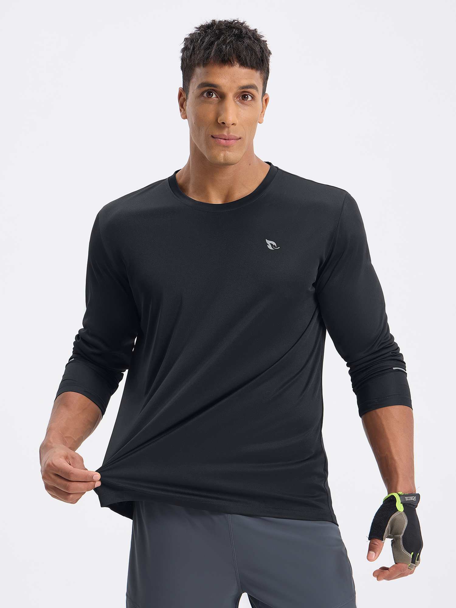 Black men's long sleeve cycling shirt, showing fabric stretch. Features logo and cycling gloves. #color_Black