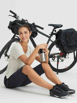 Woman in dark capri pants and t-shirt with a bicycle and water bottle #color_Black