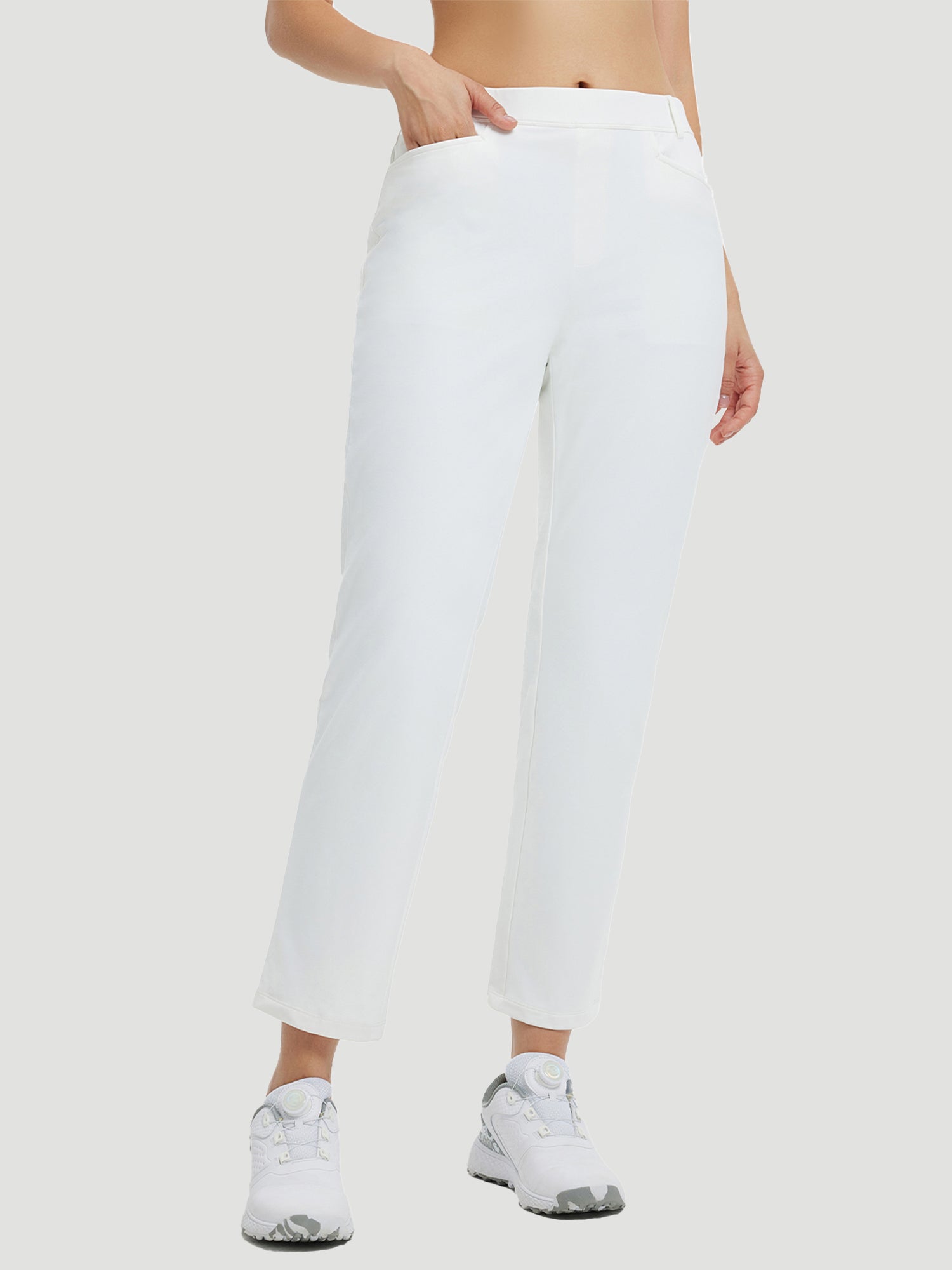 White fleece-lined straight-leg golf pants with a high waist and a woman's hand in the pocket. #Color_Star White