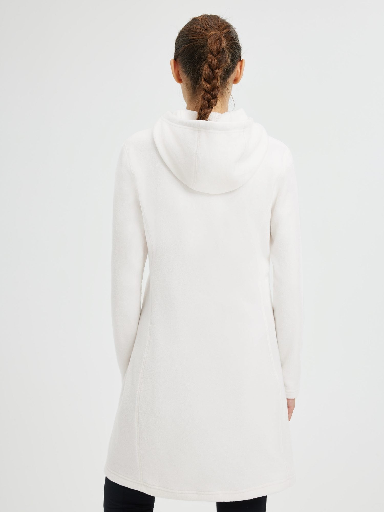 Back view of a woman wearing a white hooded fleece dress with a braided ponytail. #color_White