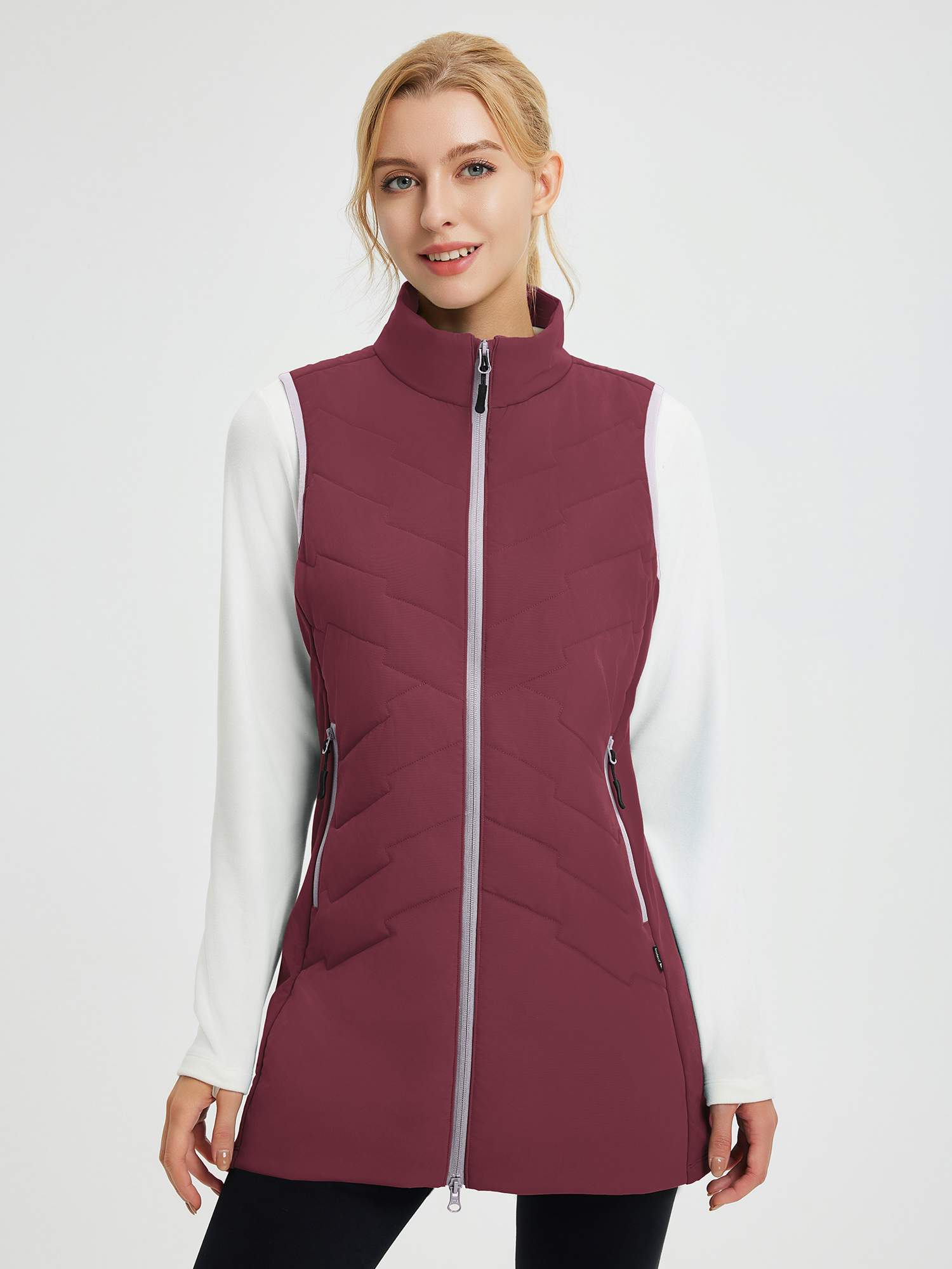 Maroon women's woven mid-length hiking vest, quilted design, zip closure, side pockets, worn over white shirt. #color_Wine Red