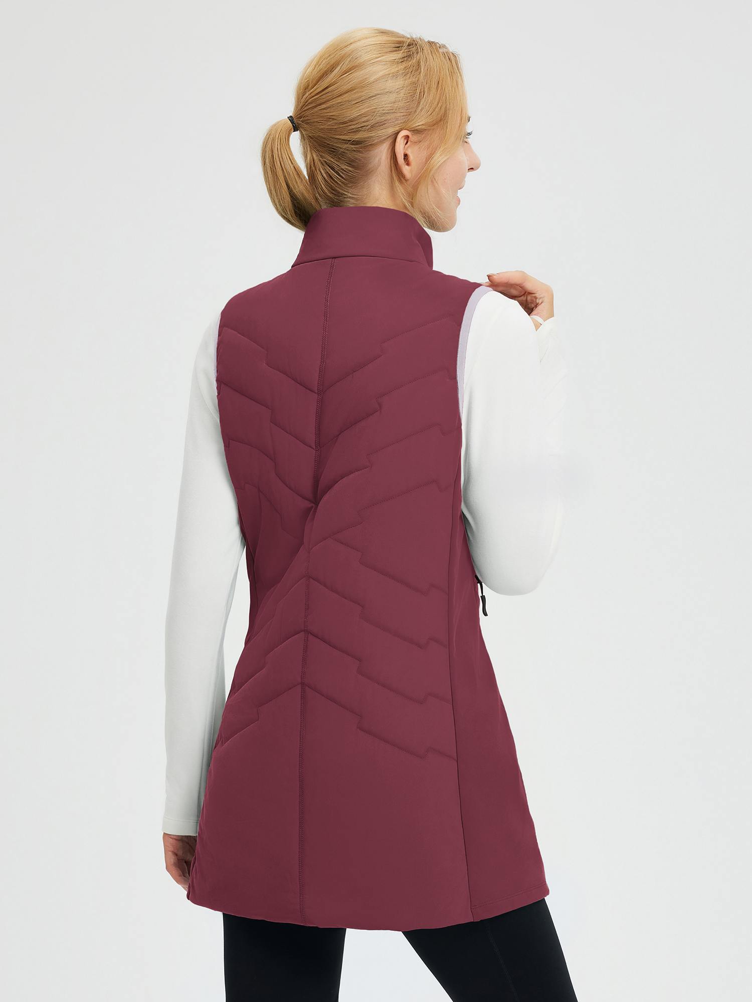 Back view: wine red women's mid-length woven hiking vest, quilted chevron pattern, over white shirt. #color_Wine Red