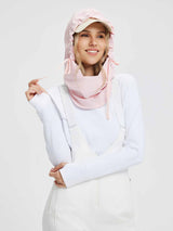 Pink fleece-lined ski hat with adjustable ties and a built-in face mask, worn by a smiling woman. #color_Light Pink
