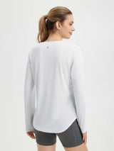 White women's long sleeve running shirt with reflective side detail and thumbholes.
