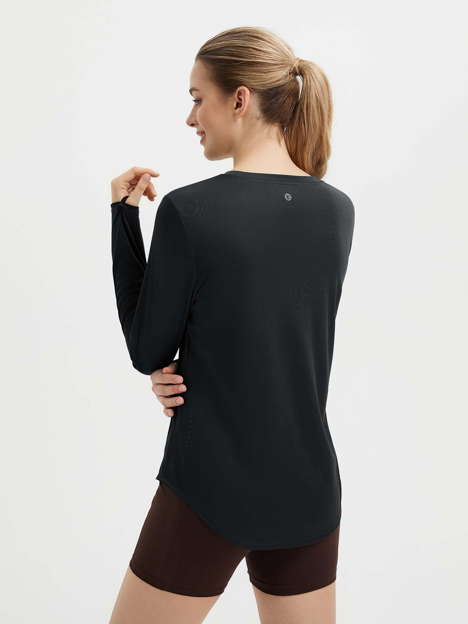 Black women's long sleeve running shirt with thumbholes and a high-low hem. #color_Black
