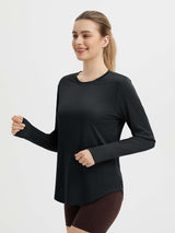 Black long-sleeved women's running shirt with thumbholes and a slightly curved hem, designed for active wear. #color_Black