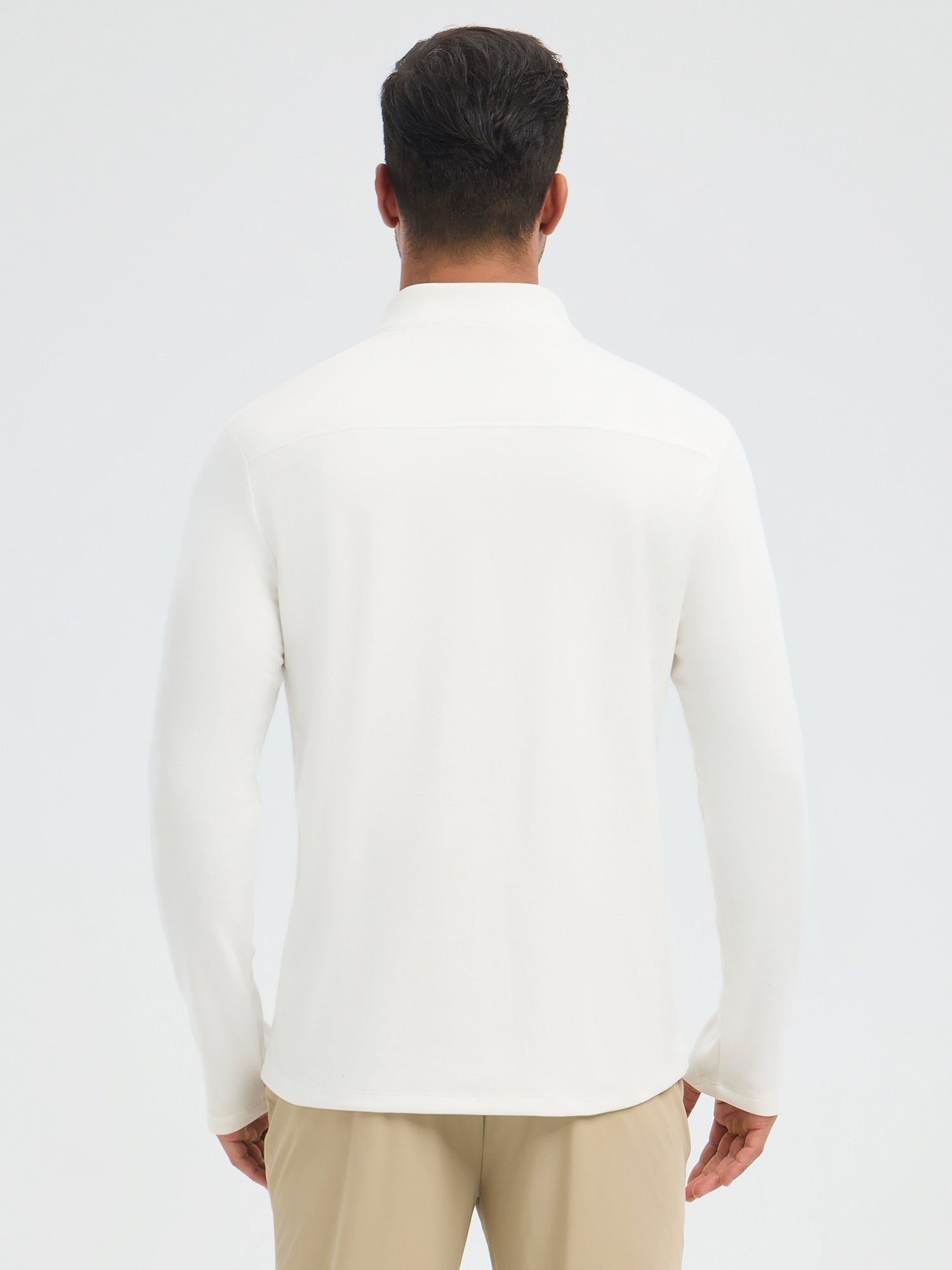 Men's white fleece running long-sleeve t-shirt with half-zip and tan pants, rear view. #color_Star White