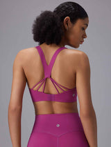 Vibrant magenta sports bra with intricate strappy back detail and matching high-rise leggings. #color_Cactus Flower