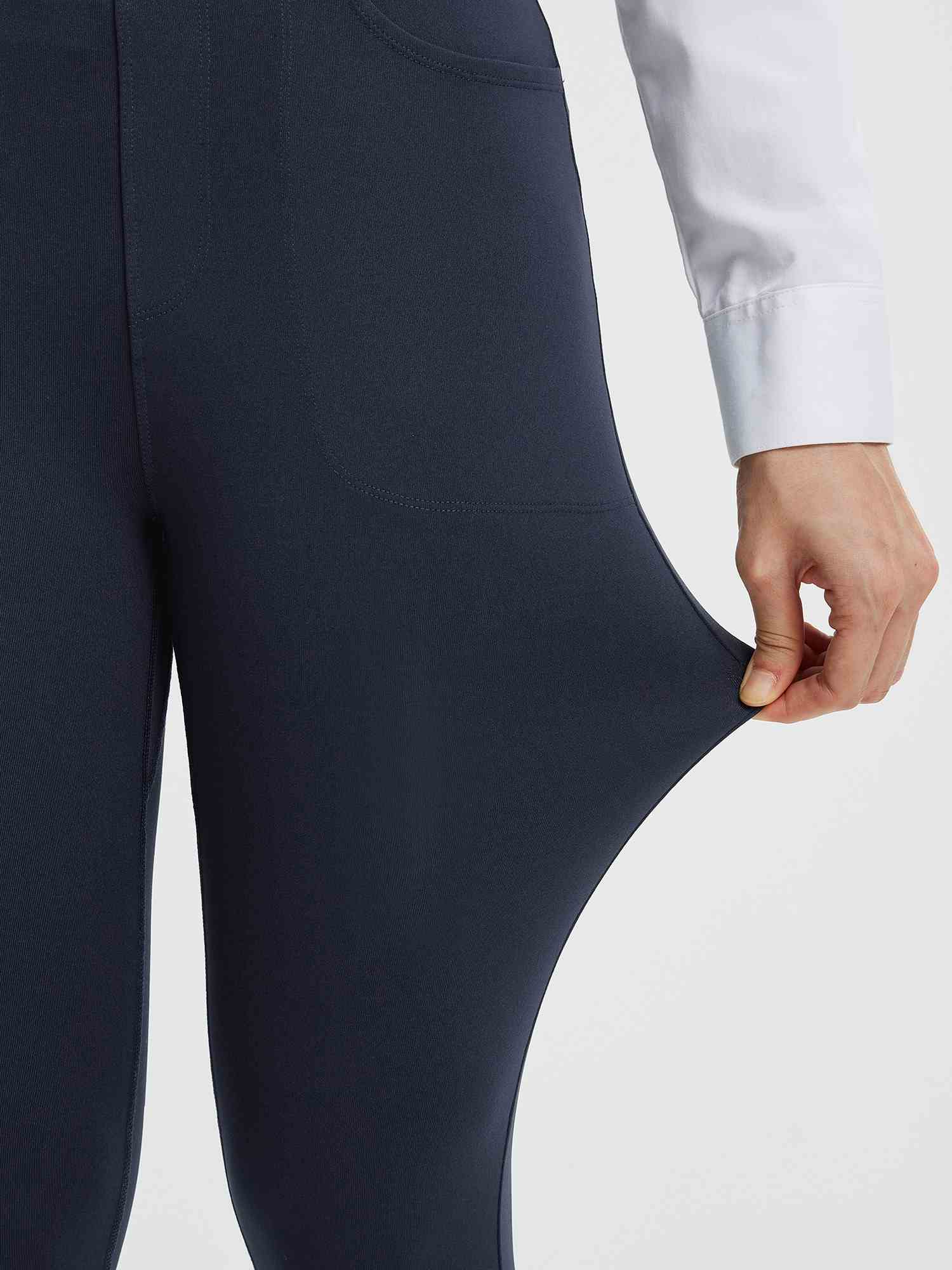Close-up of navy blue women's yoga business pants being stretched to show flexibility. #color_Navy Blue