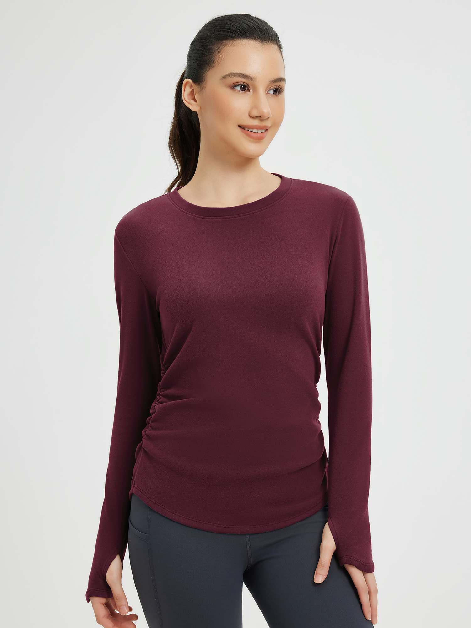 Burgundy long-sleeve yoga top with side ruching and thumbholes. Women's athletic apparel. #Color_Wine Red