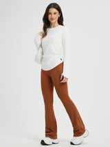 White side-ruched long-sleeve yoga top with brown flared yoga pants and white sneakers #Color_Star White
