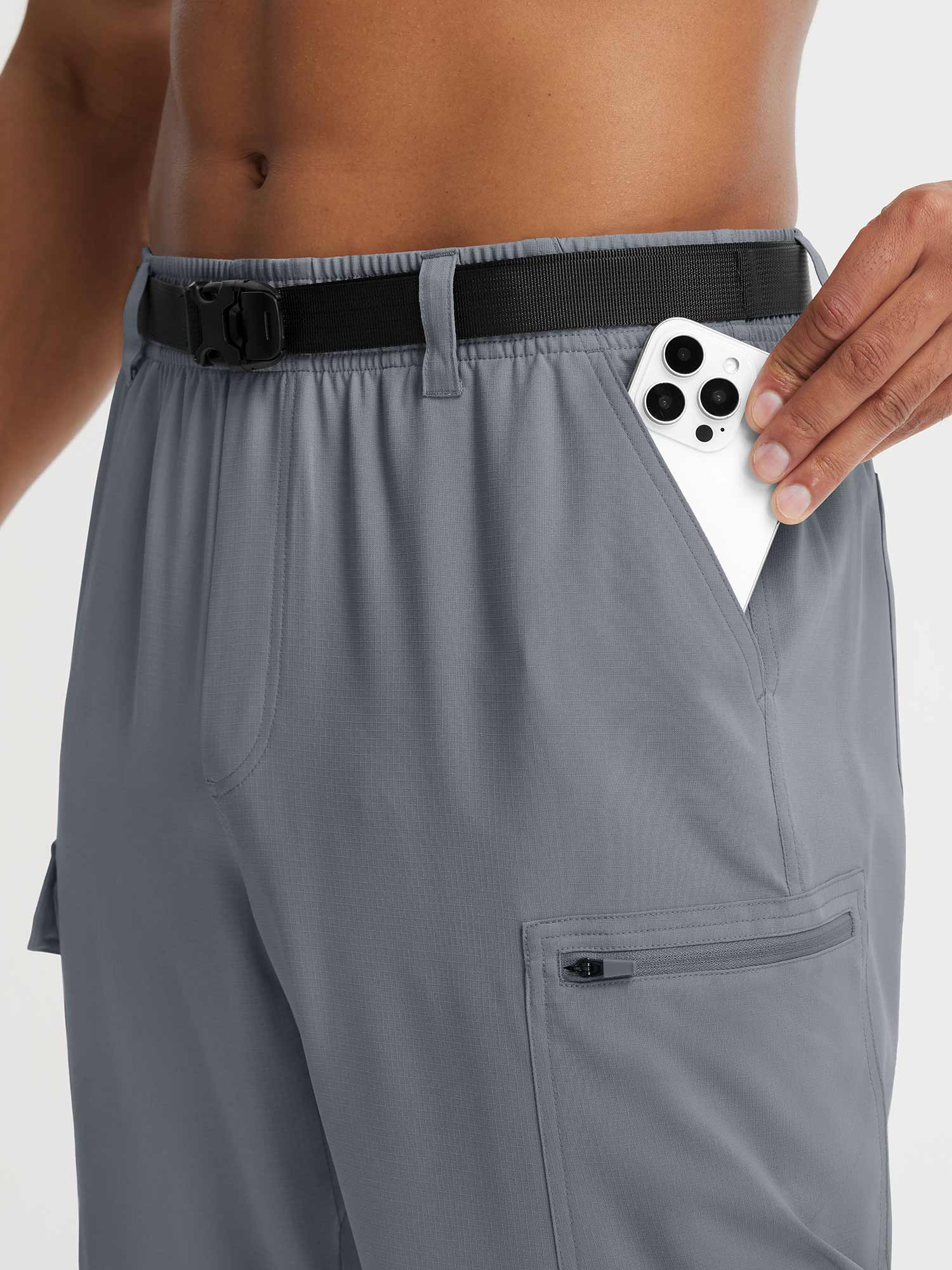 Baleaf grey ripstop hiking pants with zippered pocket holding a smartphone #color_Gray