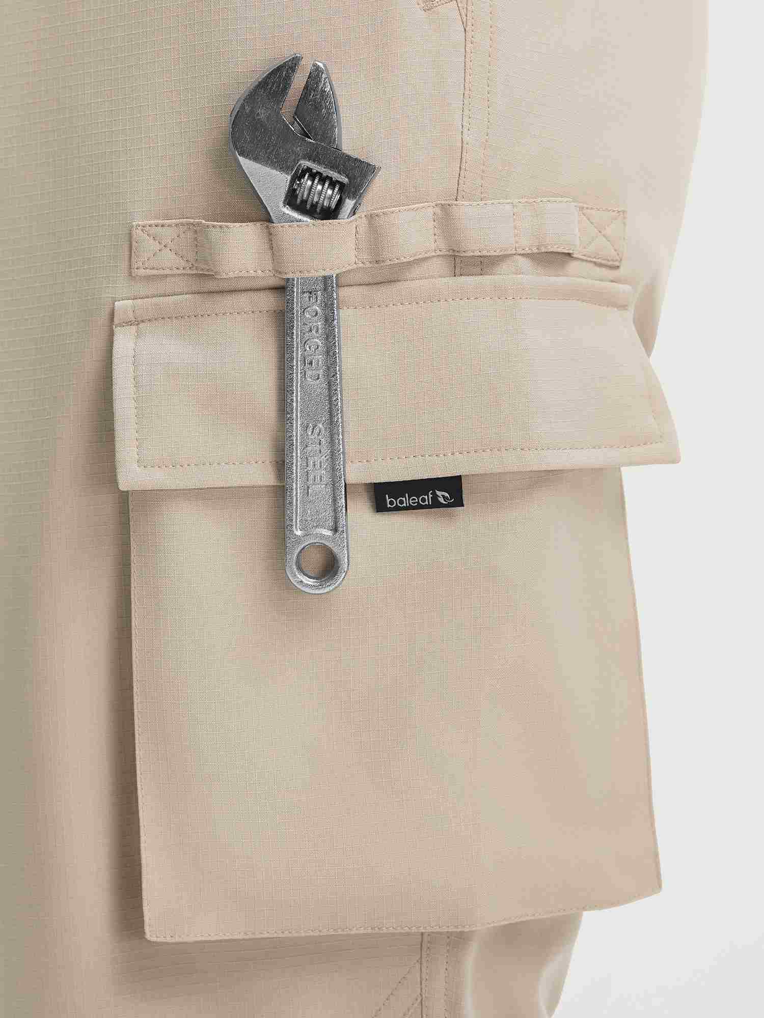 Baleaf beige ripstop hiking pants cargo pocket with forged steel wrench and logo. #color_Khaki