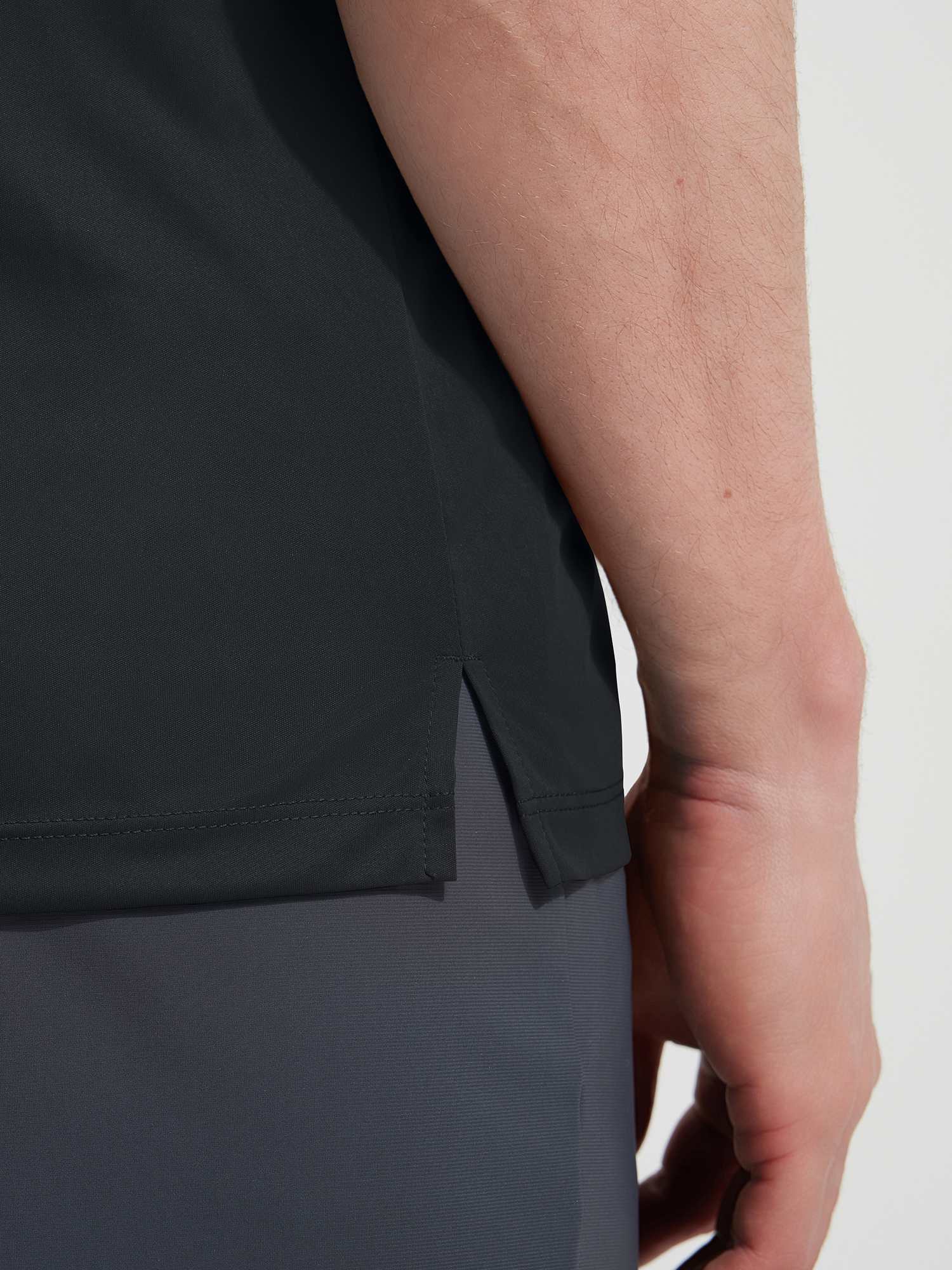 Dark grey Baleaf UPF 50+ shirt hem with athletic side slit. #color_Black