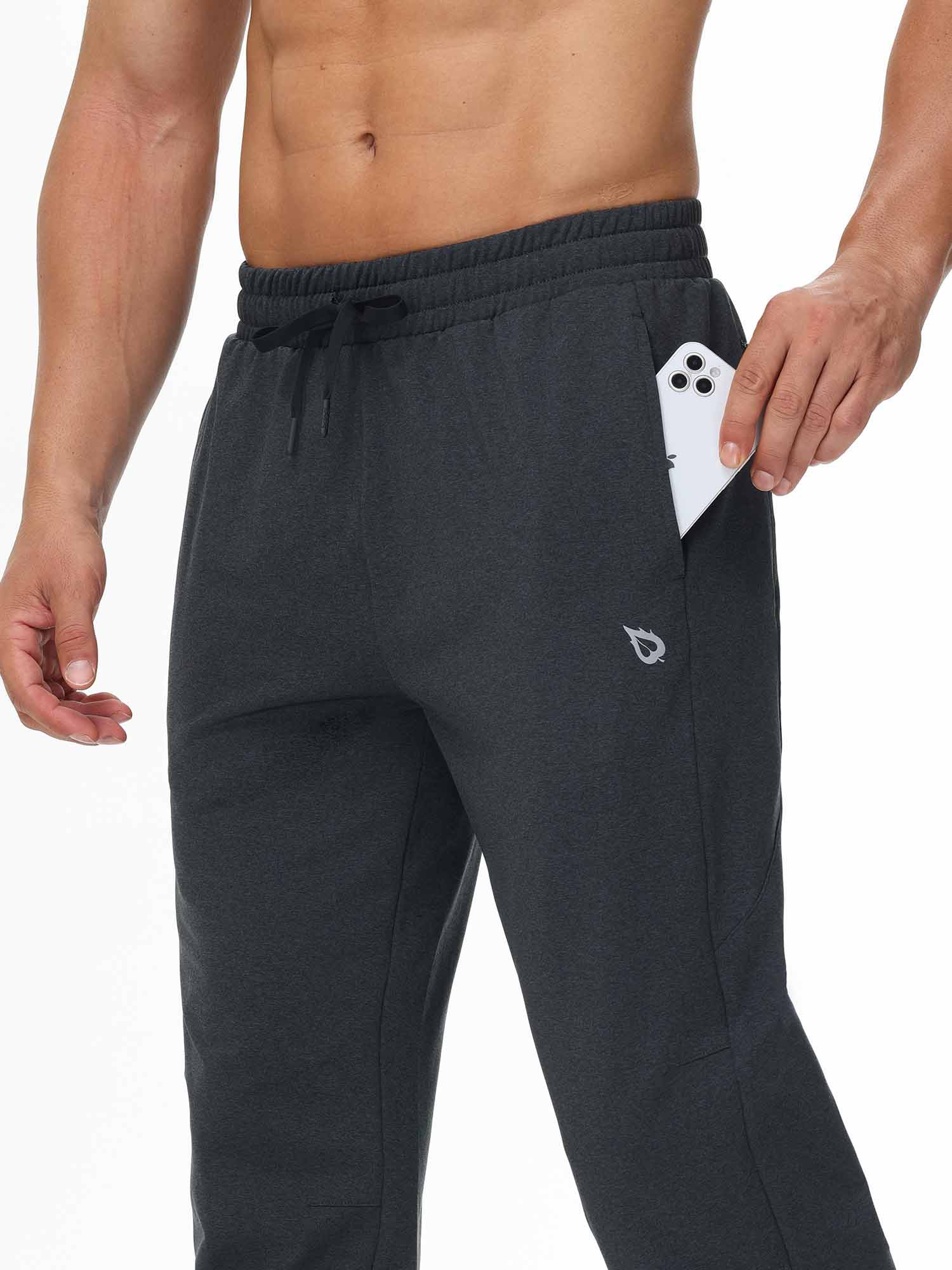 Men's dark gray fleece-lined water-resistant pants with a phone in the pocket. #color_Dark Gray