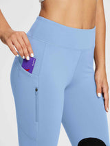 Light blue knit horse riding breeches with side pocket holding Baleaf card and zippered pocket. Stretchy material.