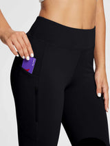 Woman placing a Baleaf branded card into the pocket of black horse riding knit skinny breeches. #color_Black