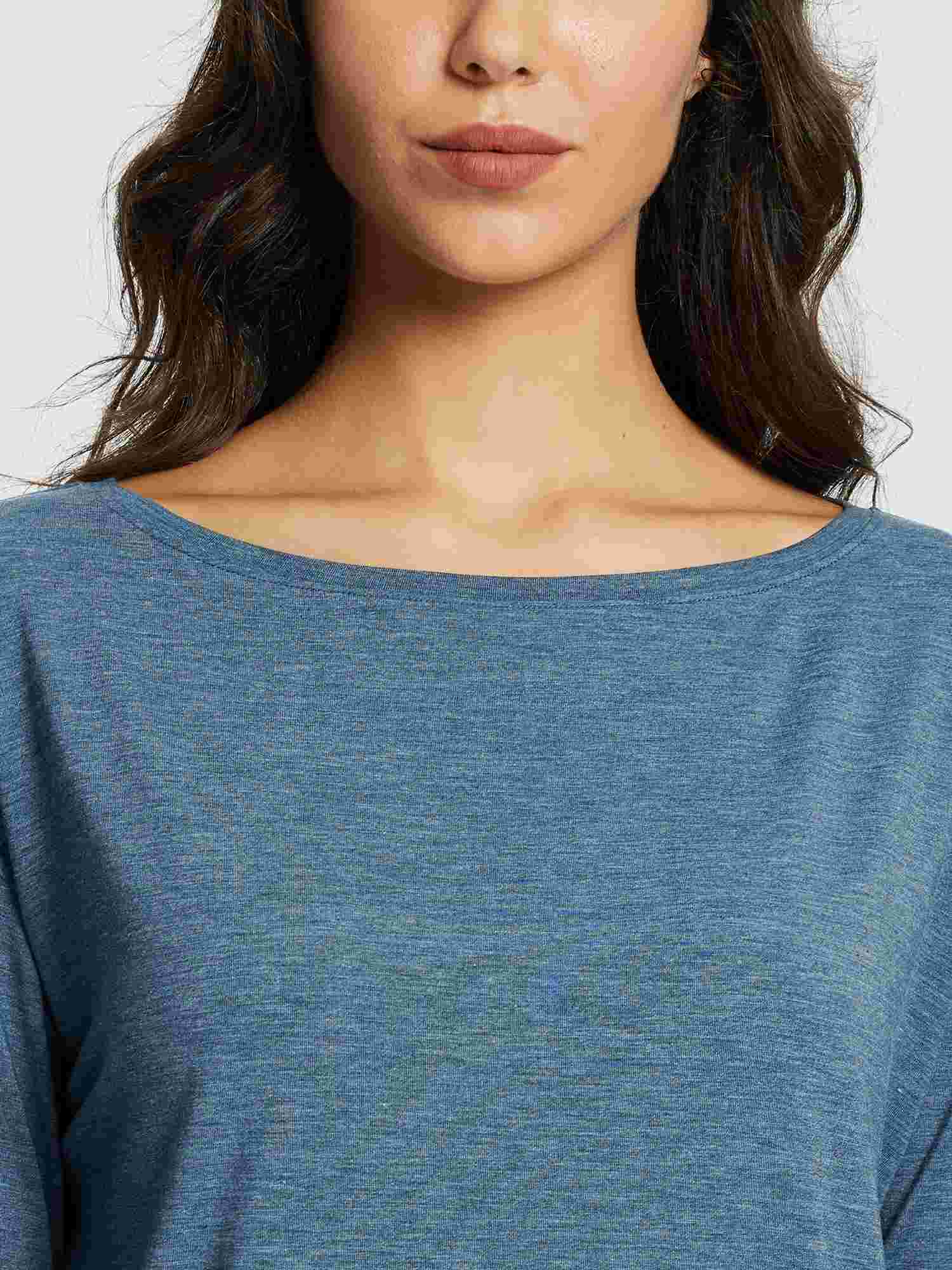 Woman wearing a blue long-sleeve workout t-shirt with a boat neckline. #color_Heather Blue