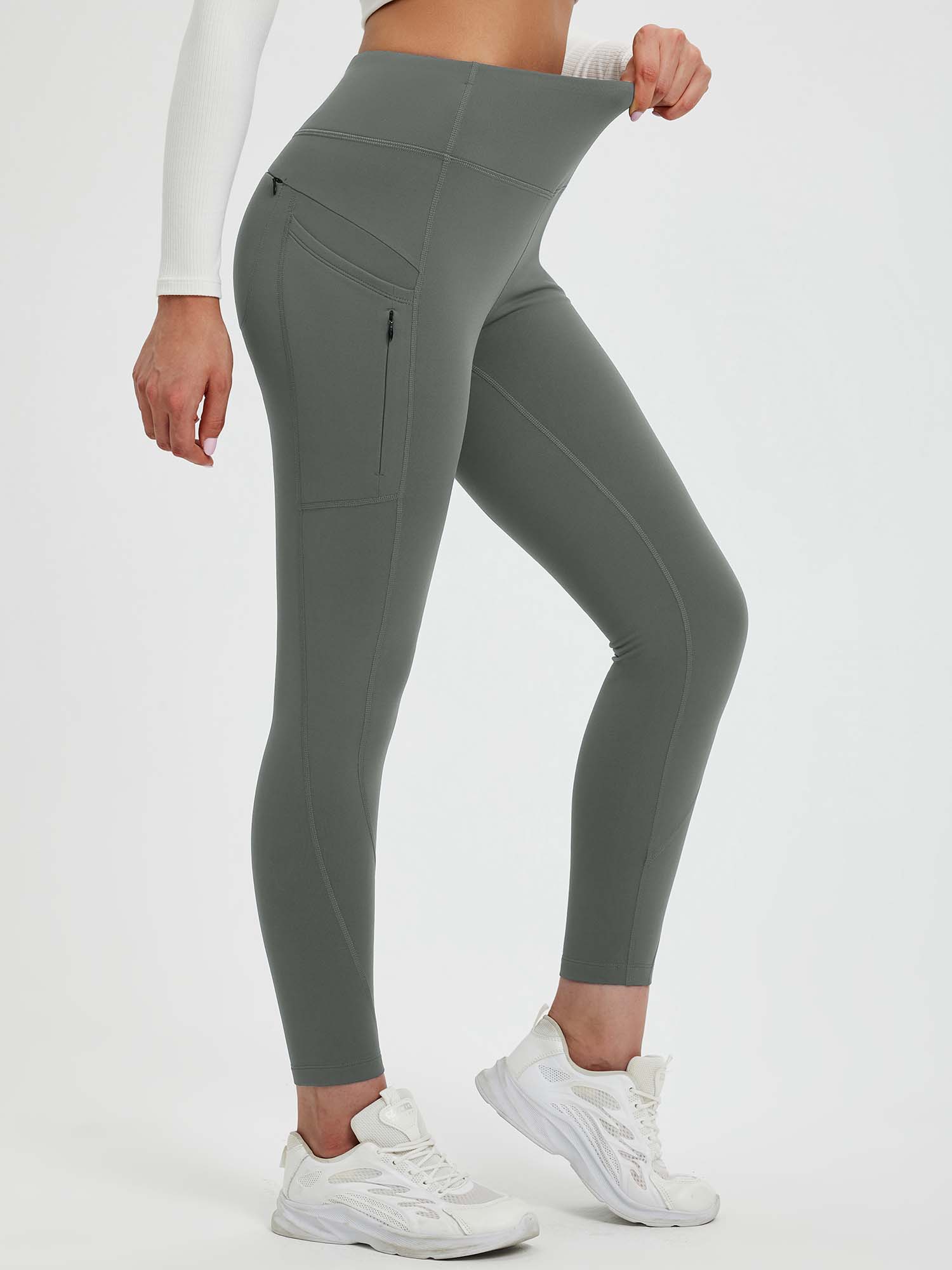 Grey 25" fleece-lined yoga leggings with side pockets and zippered pocket. High waistband, stretchy fabric. #color_Dark Gray