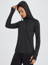 Black UPF 50+ sun hoodie shirt with thumbholes, worn by a woman in black leggings. #color_Black