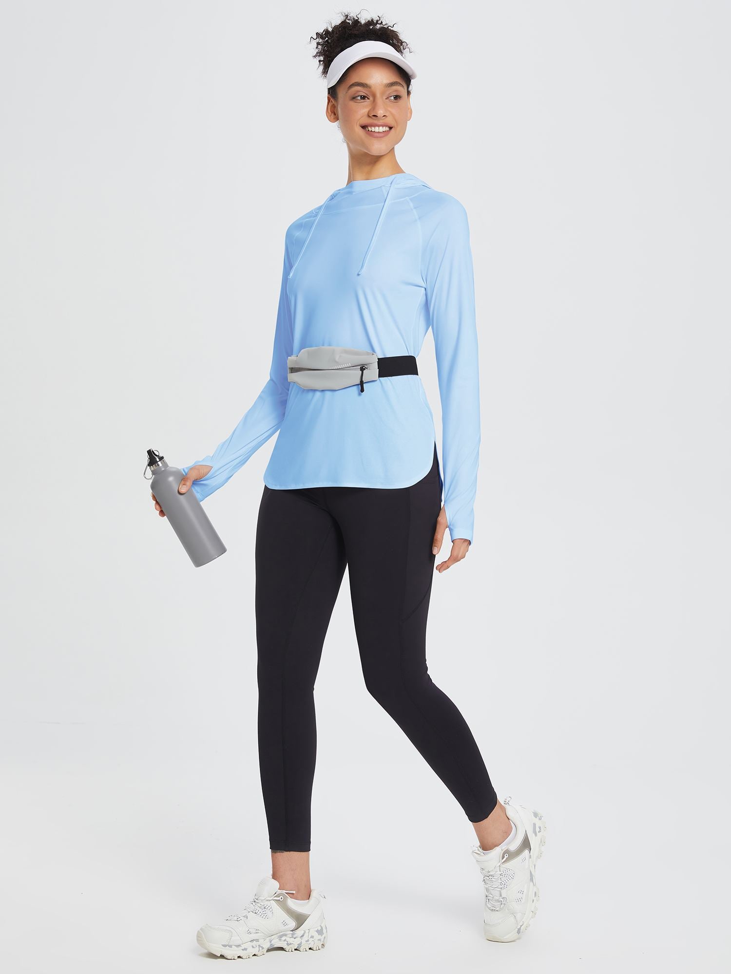 Light blue UPF 50+ sun hoodie with thumbholes, black leggings, grey fanny pack, and water bottle. #Activewear