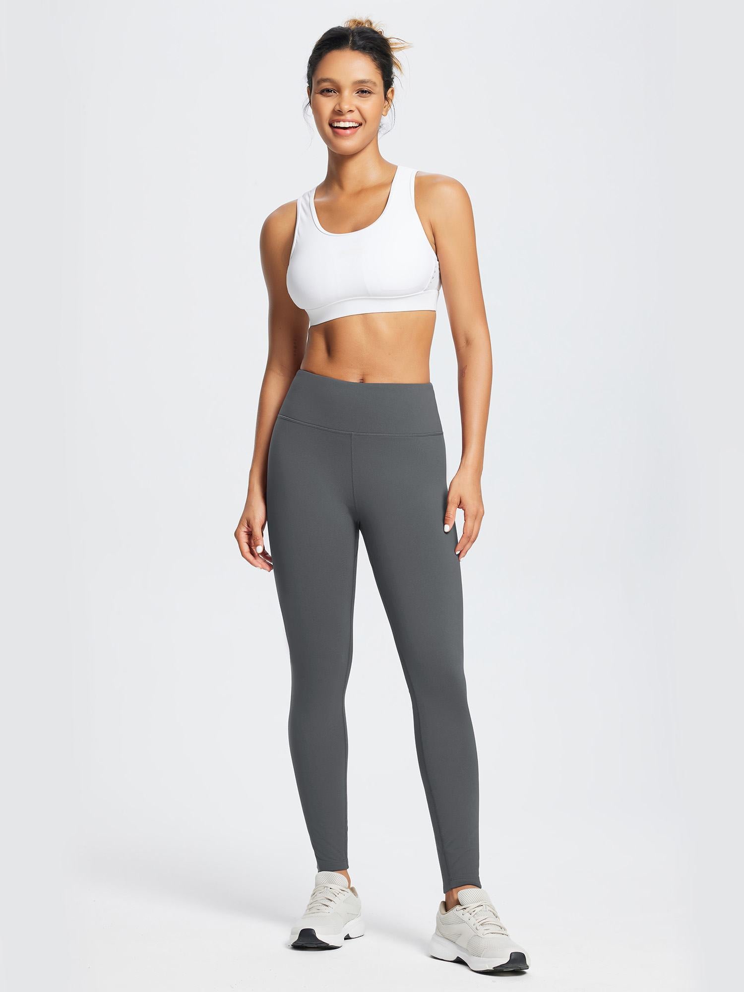 Woman wearing dark gray fleece-lined running leggings and a white sports bra. #color_Light Gray