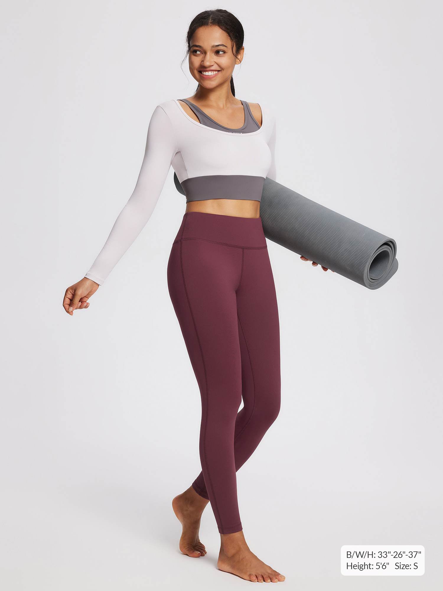 Women's petite fleece-lined yoga leggings in wine red with a white and gray long-sleeved top.