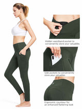 Woman in dark green high-waist yoga leggings with pockets, showcasing side and hidden waistband storage. #color_Black/Green