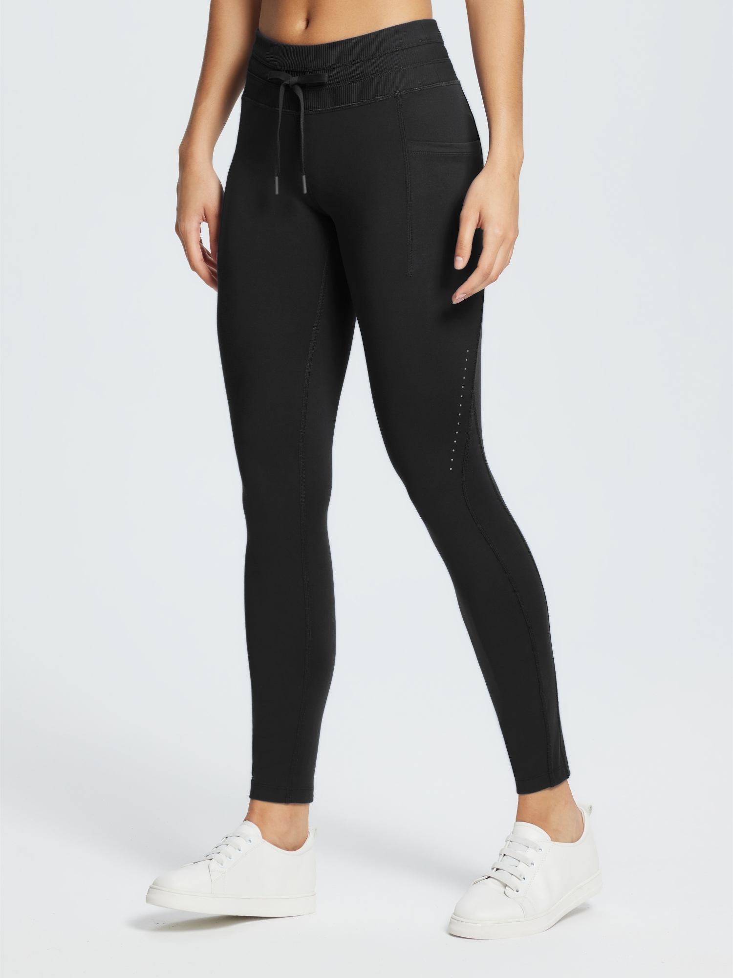 Black water-resistant 3/4 thermal ski leggings with a drawstring waist and pocket detail. #color_Black